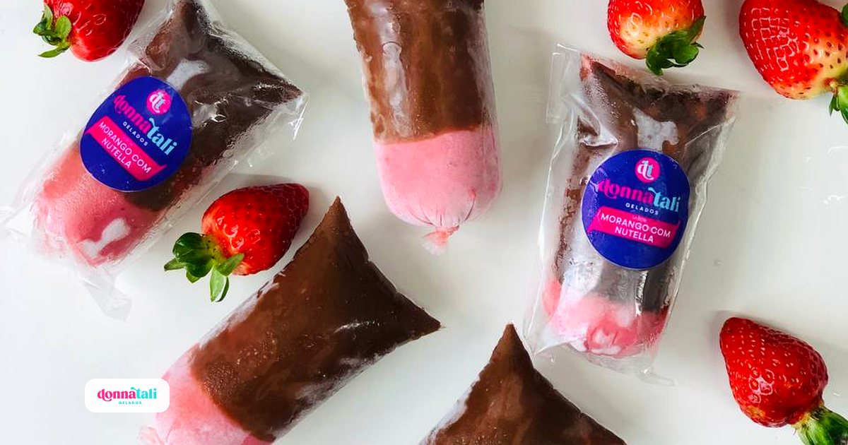 Vários geladinhos Donnatali sabor morango com Nutella espalhados sobre a mesa com morangos frescos